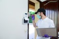 Handsome young man installing anti burglary alarm at a client house with a surgical mask and gloves COVID19 coronavirus Royalty Free Stock Photo