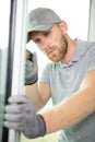 handsome young man installing bay window in construction site Royalty Free Stock Photo