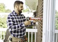 handsome young man installing bay window in a new house construction site Royalty Free Stock Photo