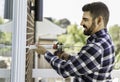 handsome young man installing bay window in a new house construction site Royalty Free Stock Photo