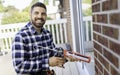 handsome young man installing bay window in a new house construction site Royalty Free Stock Photo