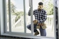 handsome young man installing bay window in a new house construction site Royalty Free Stock Photo