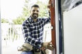 handsome young man installing bay window in a new house construction site with level Royalty Free Stock Photo