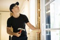A handsome young man installing Double Sliding Patio Door in a new house construction site