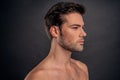 Handsome young bearded man isolated. Portrait of shirtless muscular man is standing on grey background. Men care concept Royalty Free Stock Photo