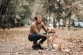 Handsome young man with labrador outdoors. Man in autumn forest with dog labrador retriever. Friendship people lifestyle animals Royalty Free Stock Photo