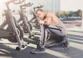 Handsome young man lace shoes at gym after training Royalty Free Stock Photo