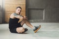 Handsome young man lace shoes at gym after training Royalty Free Stock Photo