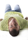 Handsome young man laying on the floor, belly up Royalty Free Stock Photo