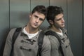 Handsome young man leaning against mirror in elevator (lift) Royalty Free Stock Photo