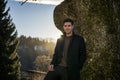 Handsome young man leaning against tree Royalty Free Stock Photo