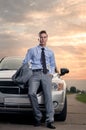 Handsome young man leaning on his car Royalty Free Stock Photo