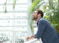 Handsome young man leaning inside bright building