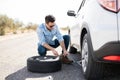 Man replacing the flat tire on the car Royalty Free Stock Photo