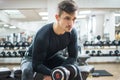 Handsome young man lifting dumbbell at gym Royalty Free Stock Photo