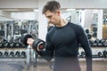 Handsome young man lifting weights in gym Royalty Free Stock Photo