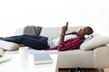 Handsome young man listening to music with headphones at home. Royalty Free Stock Photo