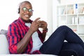 Handsome young man listening to music with headphones at home. Royalty Free Stock Photo