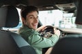 Handsome young man looking back at camera, sitting in car, parking auto, view from rear seat Royalty Free Stock Photo