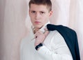 Handsome young man looking serious, holding jacket Royalty Free Stock Photo