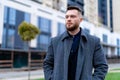 Handsome young man looking into urban street. Succesful businessman walking down the street Royalty Free Stock Photo