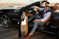 Handsome young man in luxury convertible car Royalty Free Stock Photo