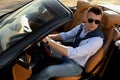 Handsome young man in luxury convertible car Royalty Free Stock Photo