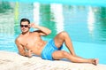 Handsome young man lying near swimming pool Royalty Free Stock Photo