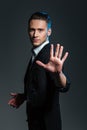 Handsome young man magician showing his palm Royalty Free Stock Photo