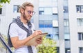 Handsome young man making notes in his sketchbook Royalty Free Stock Photo