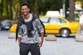 Handsome young man mixed race outdoors portrait, looking in the camera,  on a blurred street background. Royalty Free Stock Photo