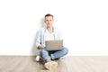 Handsome young man model sitting, posing on white wall background, wide smile. Hipster casual street style, plain unbuttoned baby Royalty Free Stock Photo