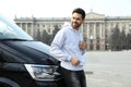 Handsome young man near modern car outdoors Royalty Free Stock Photo