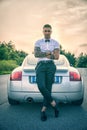 Handsome young man next to car in white shirt Royalty Free Stock Photo