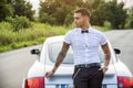 Handsome young man next to car in white shirt Royalty Free Stock Photo