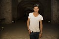 Handsome young man in old building walking inside gallery Royalty Free Stock Photo