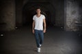 Handsome young man in old building walking inside gallery