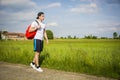 Handsome young man outdoor hiking on rural road