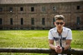 Handsome young man outdoors leaning on fence Royalty Free Stock Photo