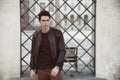 Handsome young man outside historical building in European city