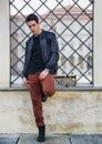 Handsome young man outside historical building in European city