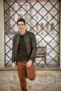 Handsome young man outside historical building in European city