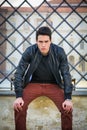 Handsome young man outside historical building in European city