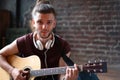 Man with guitar indoor looking at camera Royalty Free Stock Photo