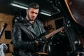 handsome young man playing guitar while sitting on bike Royalty Free Stock Photo