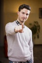 Handsome young man pointing finger at you, smiling Royalty Free Stock Photo