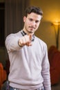 Handsome young man pointing finger at you, smiling Royalty Free Stock Photo