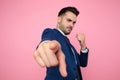 Handsome young man pointing fingers on pink background Royalty Free Stock Photo