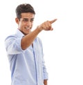 Showing you the way. A handsome young man pointing his finger and smiling against a white background. Royalty Free Stock Photo