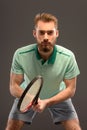 Handsome young man in polo shirt holding tennis Royalty Free Stock Photo